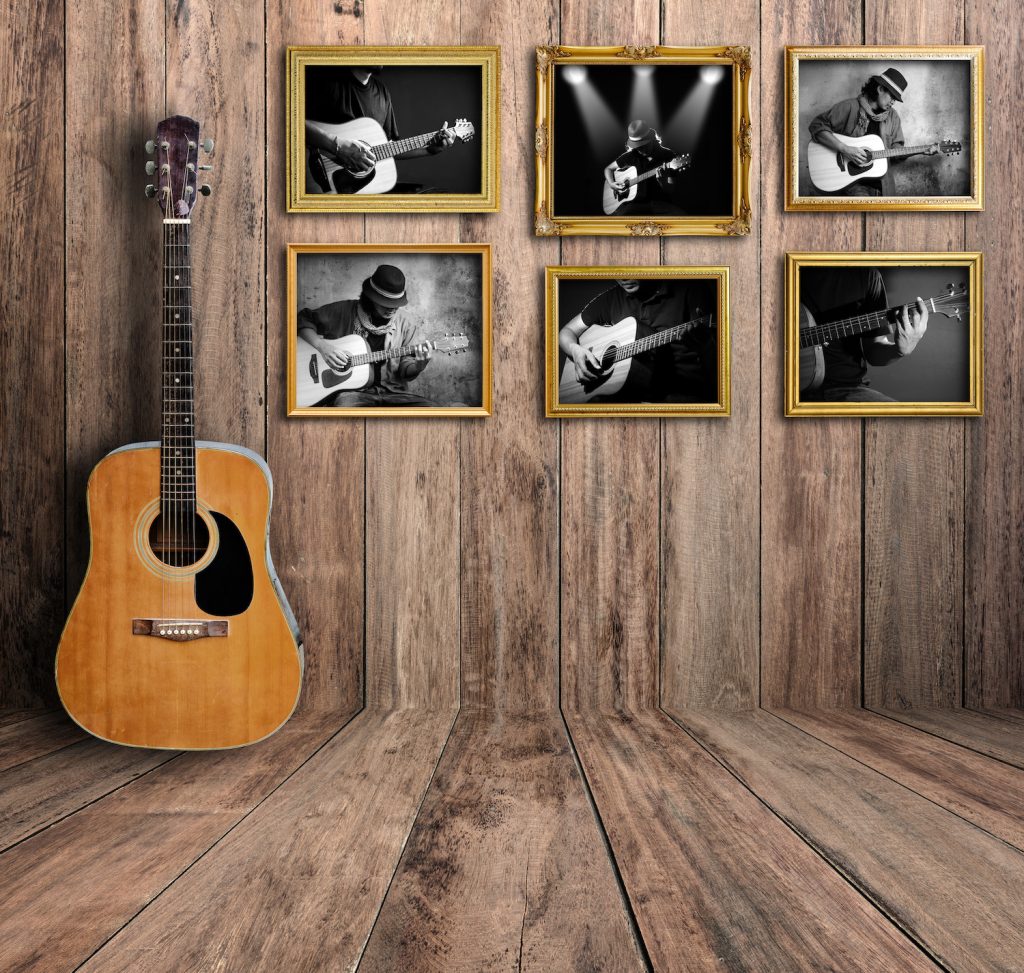 Guitar player photo in vintage wood room.