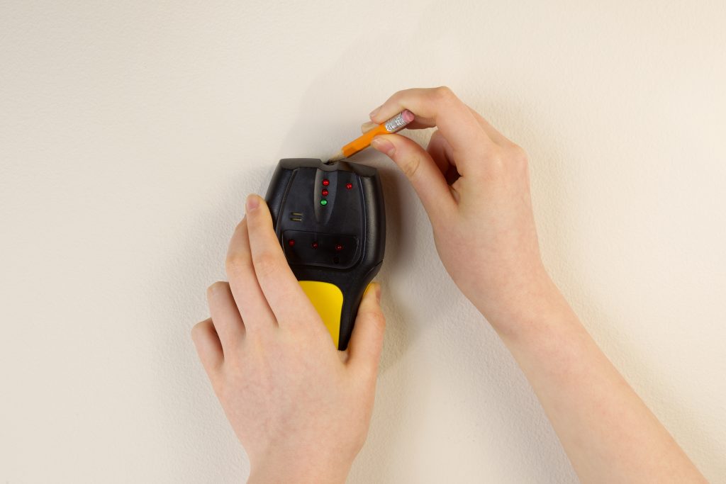 Using Stud Finder on interior home wall