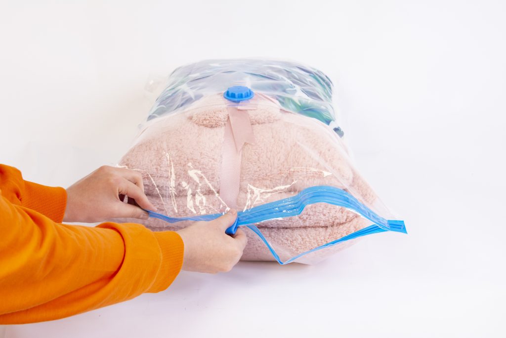 Space saver saving seal bag sucking air vacuum clothing storage compressed package.