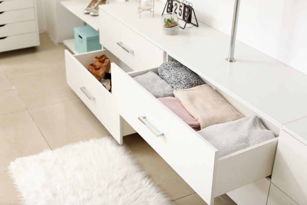 Drawers with clean clothes in dressing room