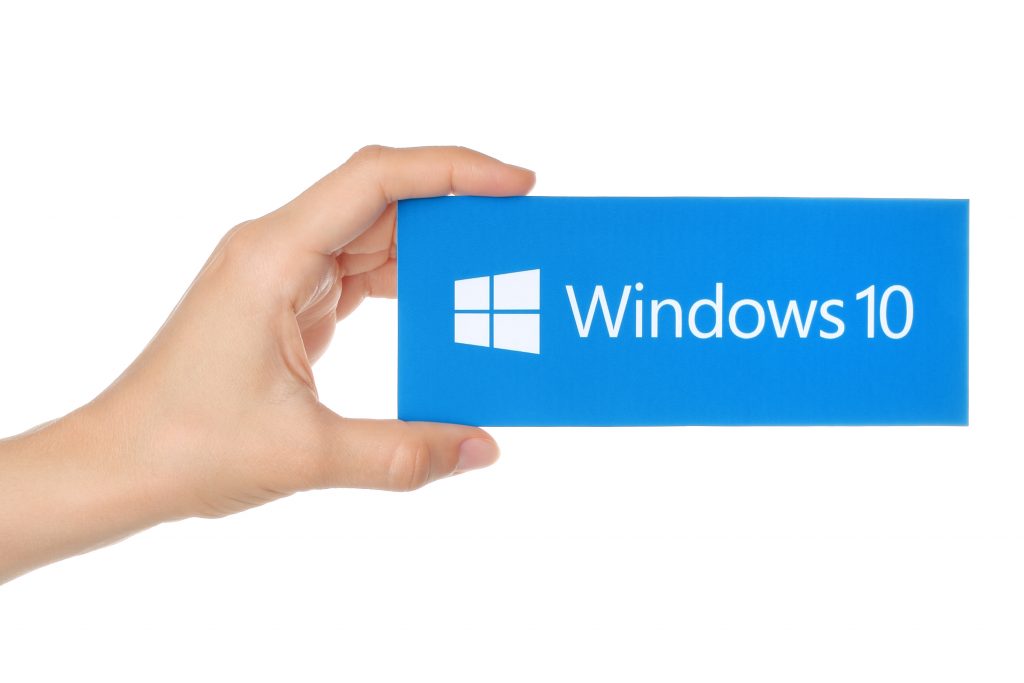 Hand holding a Windows 10 sign 