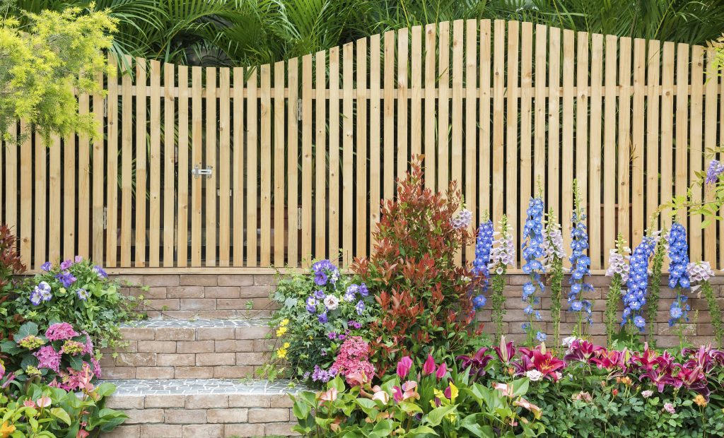 entrance and wooden fence of backyard flower garden