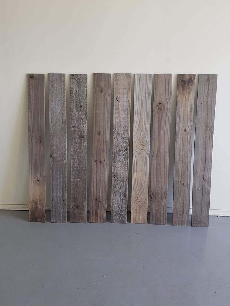 Reclaimed wood planks propped up against a wall