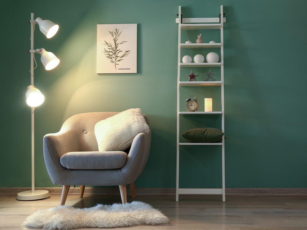 https://storables.com/wp-content/uploads/2021/04/Interior-of-modern-room-with-armchair-shelf-unit-and-lamp-in-evening-1200x900.jpeg