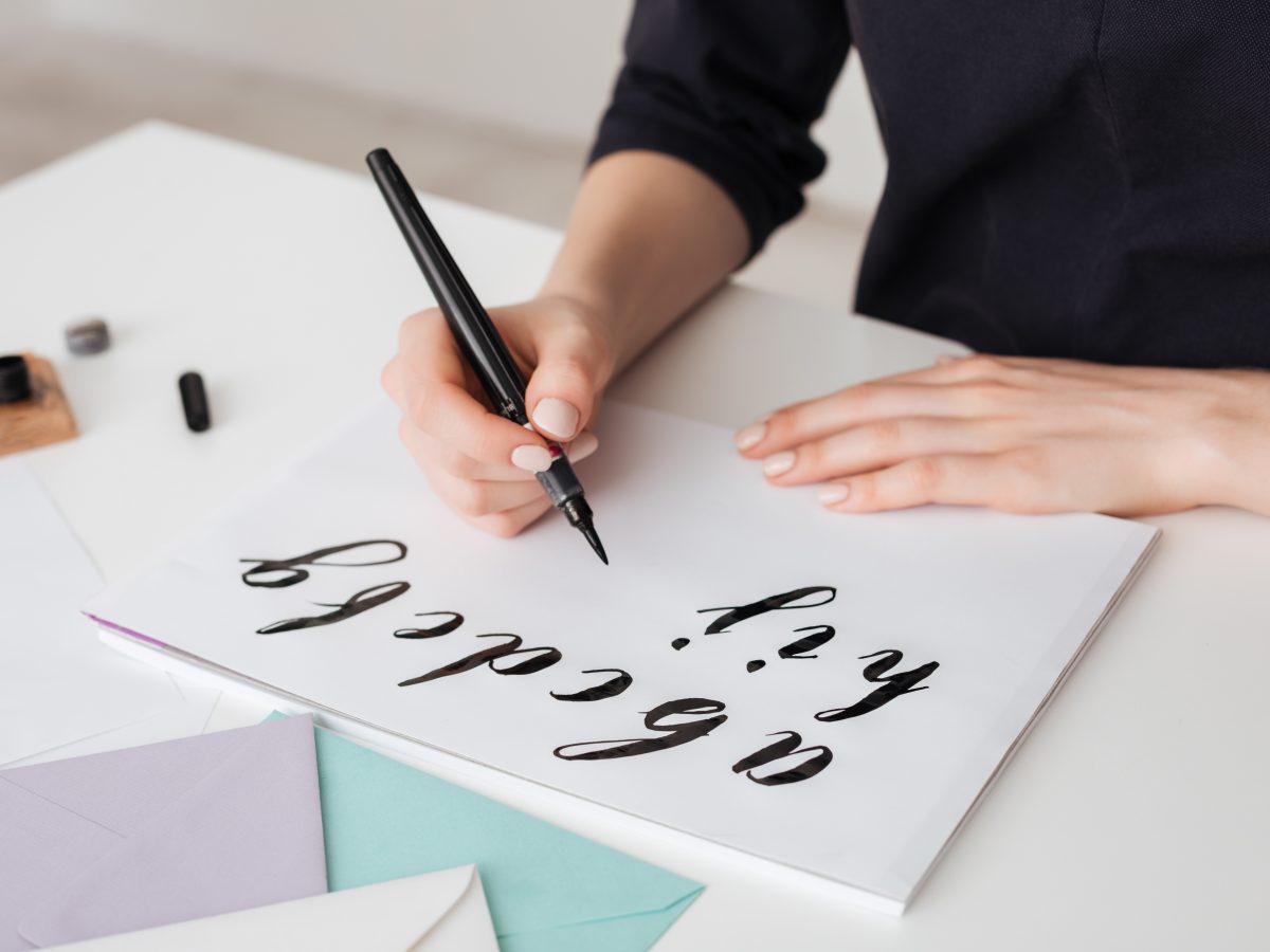 https://storables.com/wp-content/uploads/2021/05/Portrait-of-young-woman-hands-writing-alphabet-on-paper-on-desk-isolated-1200x900.jpeg