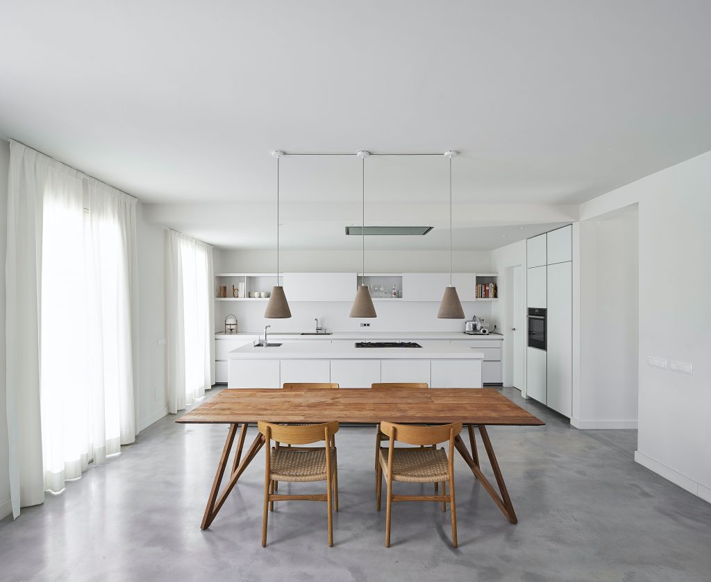 Dining area with white walls and wooden dining set