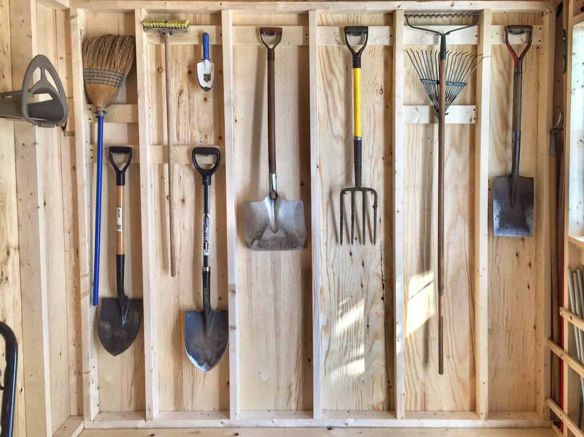 Made a garden tool rack from hooks and an old piece of lumber. Hung on the  fence to keep the tools neat…
