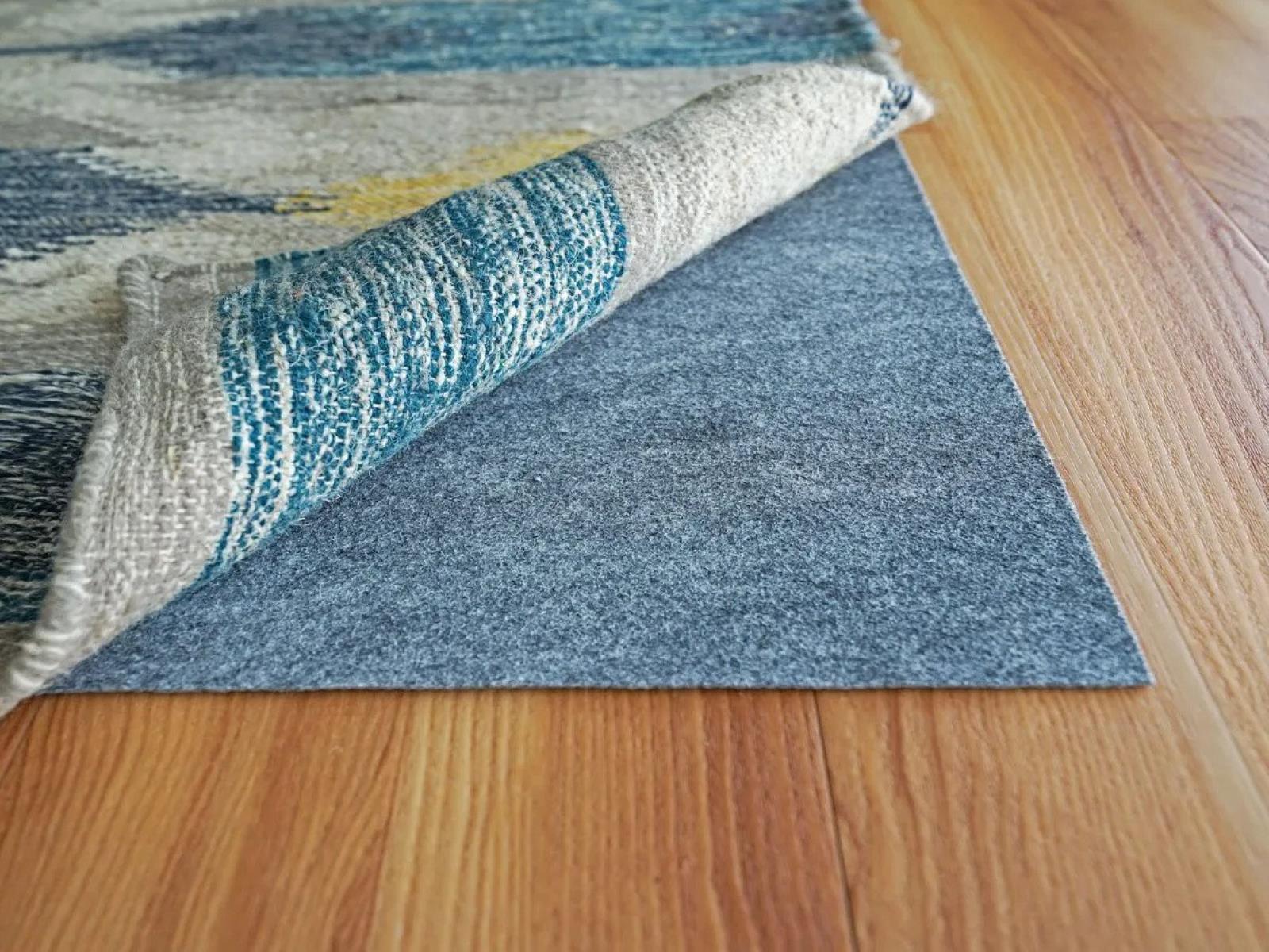 How do I stop a rug that is under my bed from bunching up?